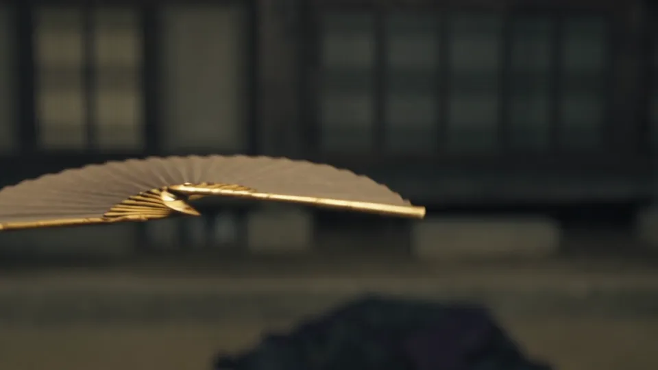 A golden fan in flight