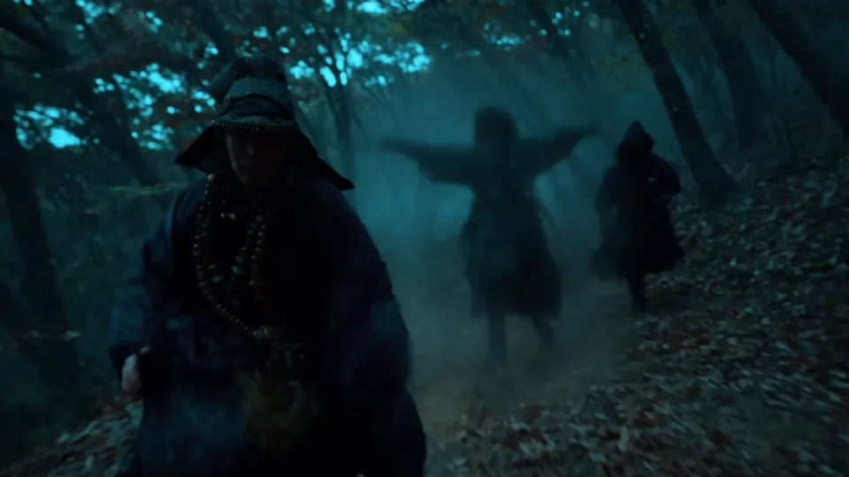 Hooded men in a blue forest